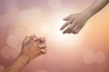 helping hand and hands praying on blurred colorful background : human hands praying and god hand are blessing, helping hand concept.