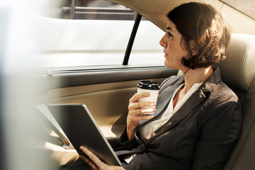 Businesswoman Using Tablet Car Inside