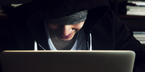 Young asian boy wearing hoodie using digital laptop