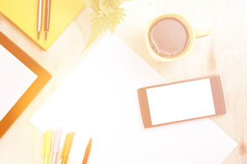 Blank screen smart phone and tablet with financial office supply on wooden background.