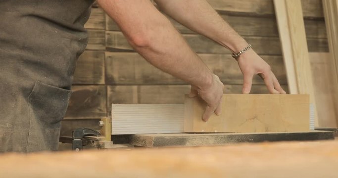 Cutting boards with electric saw, in a carpentry workshop