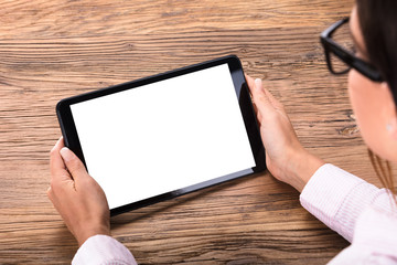 Businesswoman Holding Digital Tablet In Hand On Desk