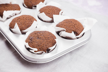 Chocolate muffins on the rustic background. Selective focus.