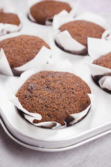 Chocolate muffins on the rustic background. Selective focus.
