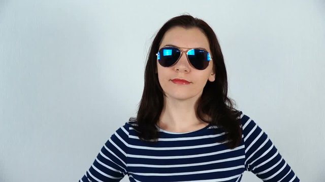 Model 30-35 years of European appearance in sunglasses posing on white background.