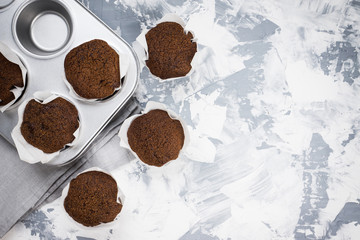 Chocolate muffins on the rustic background. Selective focus.