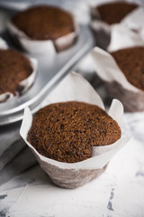 Chocolate muffins on the rustic background. Selective focus.