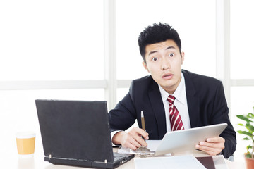 handsome asian businessman in modern office