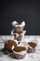 Chocolate muffins on the rustic background. Selective focus.