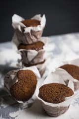 Chocolate muffins on the rustic background. Selective focus.