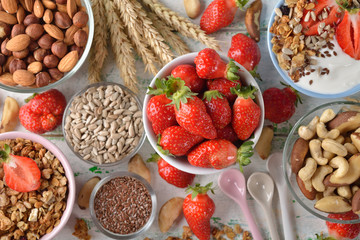 Muesli, nuts, yogurt and cereals on a white background