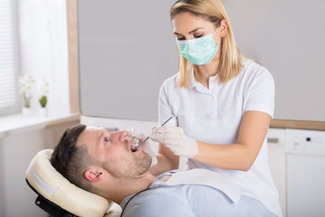 Obraz na płótnie Canvas Oral Dental Checkup With Mirror