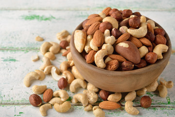 Mix of different nuts in a wooden bowl