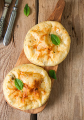 Potato herbs and cottage cheese small flat breads served on a wooden board. Copy space and top view.