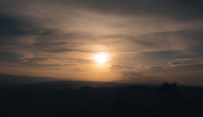 Fototapeta na wymiar Sunset on Thailand mountain with orange sky