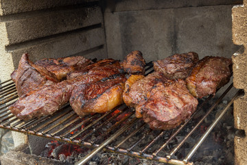 Close on many pieces of salted picanha barbecue beef from Brazil grilled on wood fire medium well done
