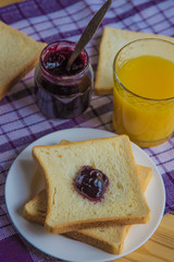 Breakfast: blueberrу jam, toast and orange juice