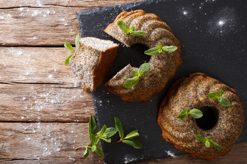 Homemade bundt cake with poppy and mint closeup. horizontal top view