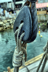 Ancient wooden sailboat pulleys and ropes detail