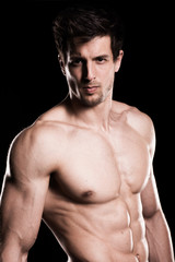 Fototapeta premium Sexy Shirtless Muscular Male Model on Black Background