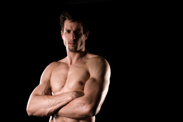 Fototapeta na wymiar Sexy Shirtless Muscular Male Model on Black Background