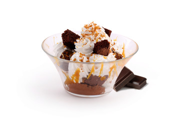 Chocolate ice cream with caramel sauce, whipped cream and chocolate sponge cake 