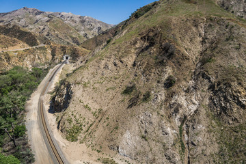 Railroad bend in the tracks leads to a tunnel in the San Gabriel mountains of southern California.
