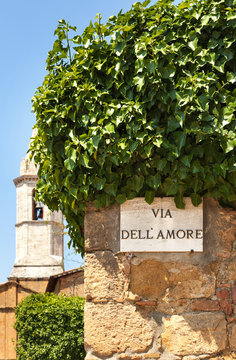 Fototapeta A sign on the wall in Pienza town. Italy