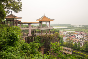 Pavilion with traditional Asian roof on  rock