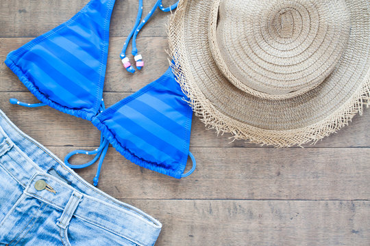 Flat lay of Summer Beach items for woman on wood background