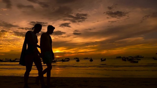 Slow Motion People walking on tropical beach at sunset. Koh Tao island
