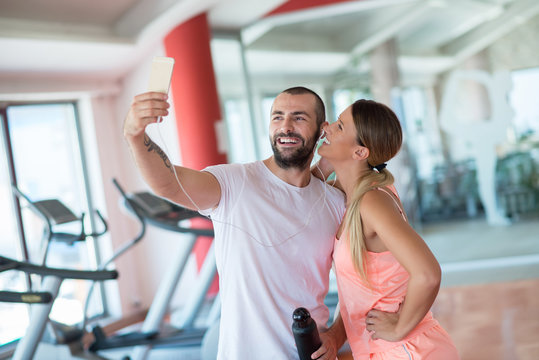Young couple taking a sefie in a gym