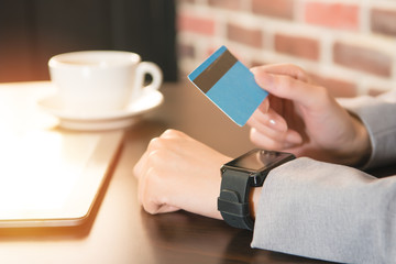 female hands smart watch and credit card