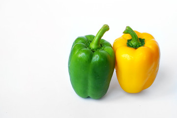 Group of sweet green peppers and yellow peppers, also known as Bell pepper or Capsicum - Fresh vegetables isolated on white background.