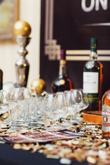 Empty glasses stand on black table with whisky