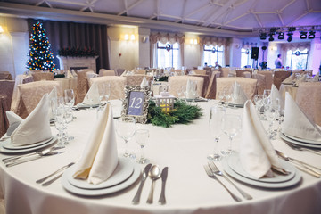 Serviettes stand on dinner plates on the table number 12