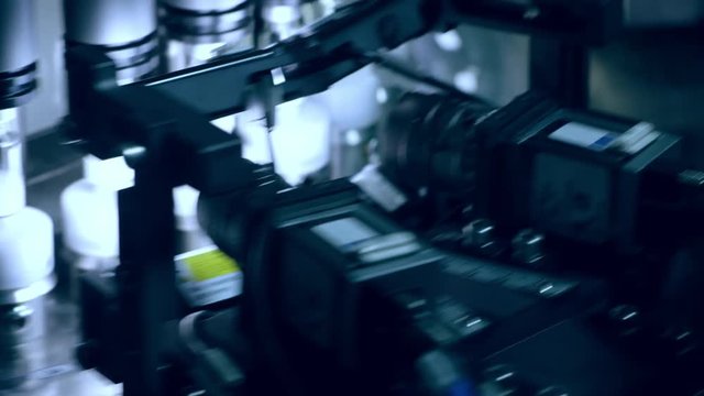 Pharmaceutical quality control equipment. Close up of automated optical inspection machine. Machine control quality of medical vials. Automated production line at pharmaceutical factory