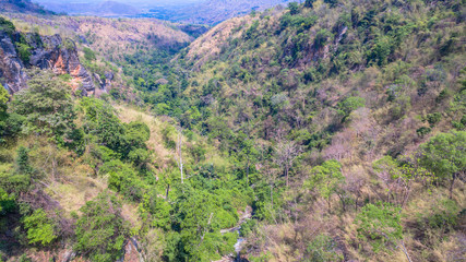 aerial photography above amazing cave. Tham Than Lod Yai is the big cave and have one hole on the top of the cave. it is a short cave there have waterfall pass inside through to another cave
