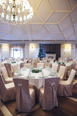 Look from above at dinner table decorated with fir