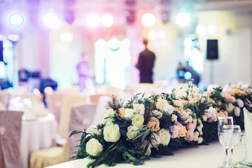 Look over the garland of roses at people in the restaurant