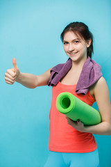 Happy girl holds fitness mat