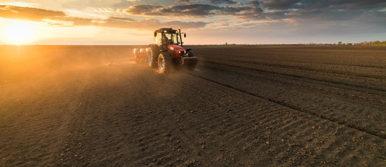Farmer with tractor seeding - sowing crops at agricultural field in spring © Dusan Kostic