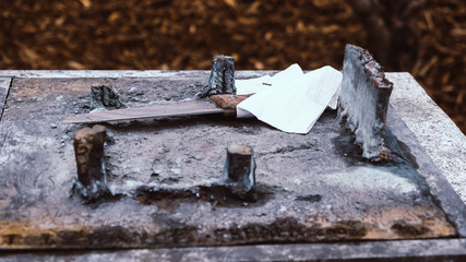 Crime scene. A knife abandoned on a wall, the handle is surrounded by a handkerchief.