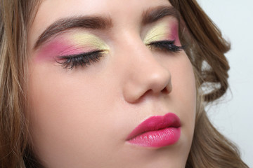 Fototapeta premium Portrait of a young girl with a beautiful bright make-up on a neutral background
