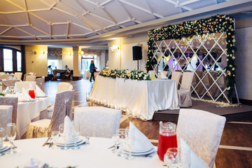Table for wedding couple decorated with garland of roses