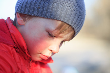 Close-up portrait of an emotional boy in a bad mood