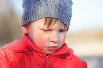 Close-up portrait of an emotional boy in a bad mood