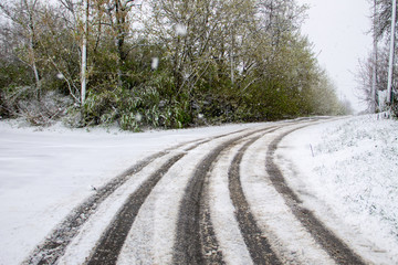 Snowy road during sudden April snow storm in Ukraine. April snow cyclone