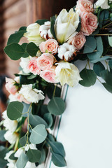 Roses and lilies put in a decoration of an easel