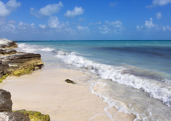 Sea shore. The coastline of the Caribbean sea. Cloudy sky on a partly sunny day.